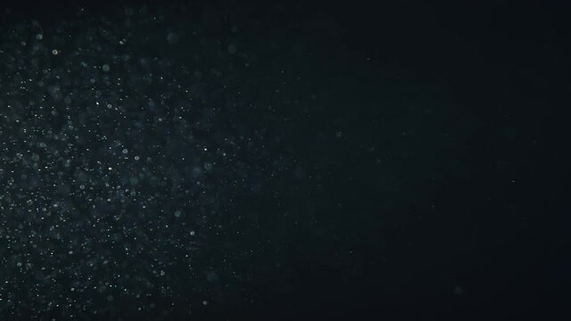 Video of underwater colorful bubbles rising to surface in slow motion 180fps. Close up, refreshing soda tonic fizzy water, bubbles dissolve in mineral carbonated drink. Bubbles particles rise up.