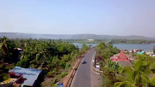 Drone shot flying over a Siolim bridge in Goa, India.