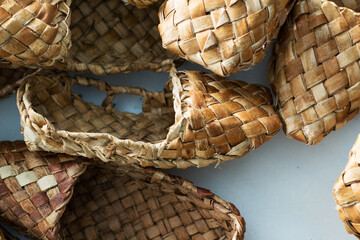 woven shoes made of wood bark from the master on the table