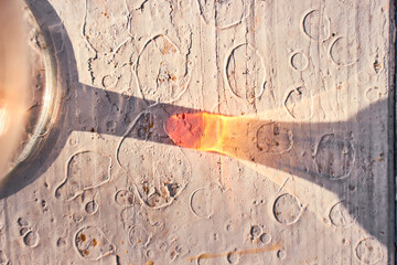 
glass glass with a drink, the reflection of the sun on the table shadow