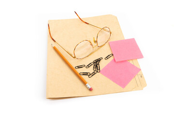 a pencil, file folder, sticky notes and reading glasses getting ready for frustration at tax time