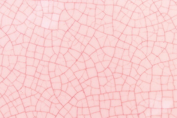 Pink and white crack ceramic tile. Pale red color of glazed tile texture abstract background....