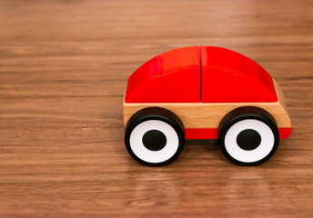 Wooden and plastic toy car in the afternoon sunlight