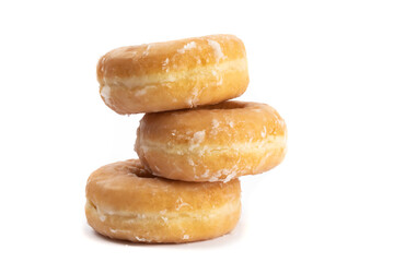 a pile of three sweet honey glazed donuts isolated on white