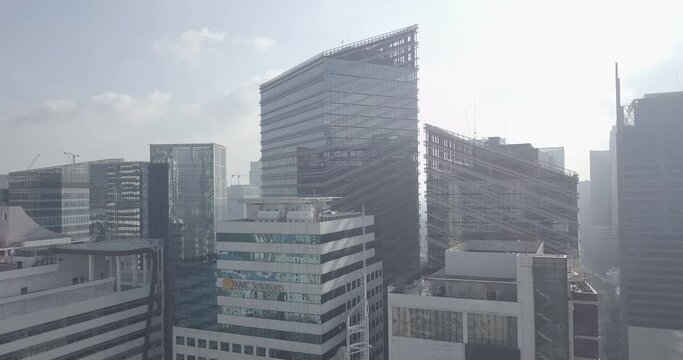 Ungraded, Ascending aerial flight through business district's skyscrapers to reveal metropolitan city. Drone, 4K
