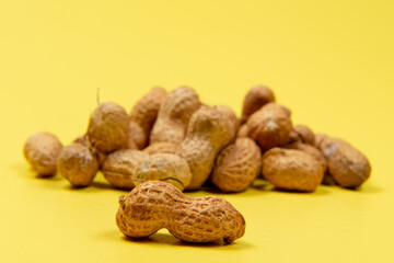 shelled peanuts on yellow background