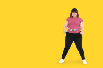 Fototapeta na wymiar Fat Asian women exercise to lose weight, use a waist tape to check their shape. Health care concept. Yellow background. Clipping Path. isolated