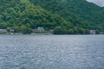 Lake Chuzenji and mountains landscape with waterfront buildings