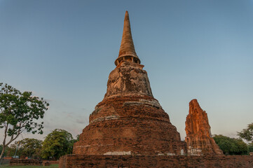 Fototapeta na wymiar Ruins of old Thai Buddhist temple. Red brick chedi stupa
