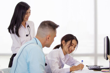 Fototapeta premium Portrait of call center team working together in the office. Helpdesk staffs working in the office surrounding with a good working environment. Operator team in company communicate to client