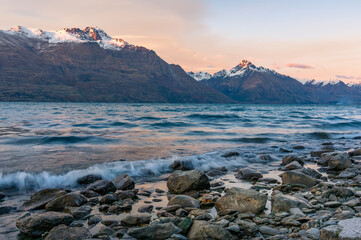 Winter mountain landscape with icy lake and snow-capped mountains