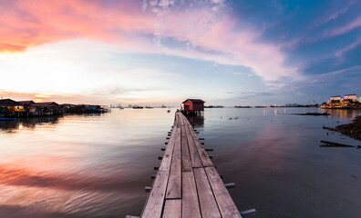 Wooden bridge Clan Tan Jetty view during sunrise in George Town, Penang