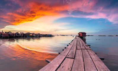 Wooden bridge Clan Tan Jetty view during sunrise in George Town, Penang