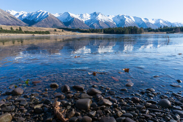 Winter mountain landscape with icy lake and snow-capped mountains