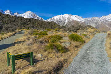 mountain valley landscape with hiking path with directional sign