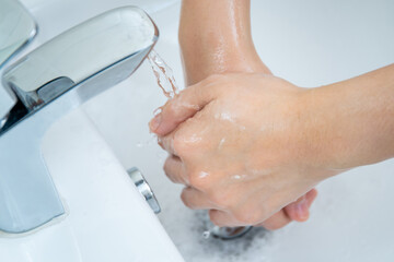Woman washing her hands by using liquid hand washer soap for protecting from coronavirus 2019,...