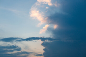 
Beautiful dramatic gray and white clouds on blue sky, variety of shapes, silhouettes and shades at sunset time