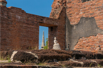 Buddha statue figurines, small sculptures with old ruins on the background