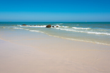 Fototapeta na wymiar Empty beach with sand, clear water and soft waves