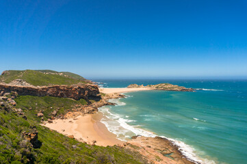 Beautiful ocean coastline landscape background with cliffs and sandy beach