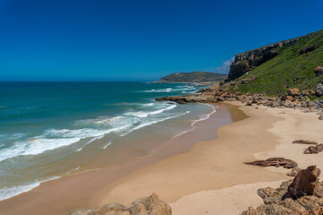 Beautiful South African coastline with mountains and inviting sandy beach