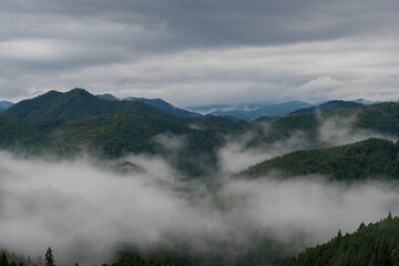 Mountain peaks with low clouds, fog or mist