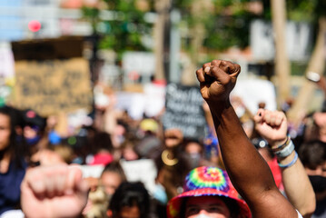 Miami Downtown, FL, USA - MAY 31, 2020: Black hand at a peaceful protest. Human rights. The situation in the USA with demonstrations after Minneapolis killing. death. - obrazy, fototapety, plakaty