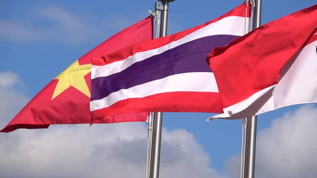 Flags of Vietnam, Thailand, and Singapore waving in wind. Real time. 4K
