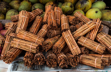 Pile of Fresh cut cinnamon sticks on fruit market stall in Sri Lanka
