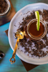 black tea on a vintage background, for a hot day, organic with a bottle