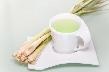 Lemon grass drink with a white cup view in close up with blur isolated background