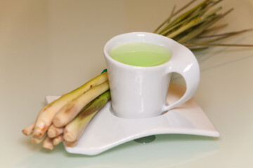 Lemon grass drink with a white cup view in close up with blur isolated background