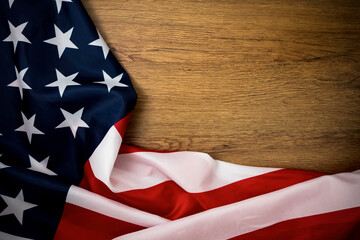 Crumple of USA flag on beautiful wooden table background. it is symbol of 4th July is United States of America national day or independence day.