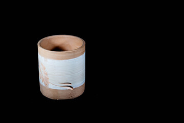 Empty ceramic pot in a black isolated background