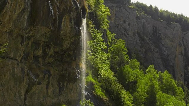 Water cascading down rock face caught in sunlight, Spanish Pyrenees