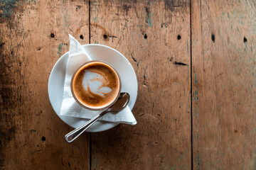 Fresh brewed Italian coffee latte served on wooden background 
