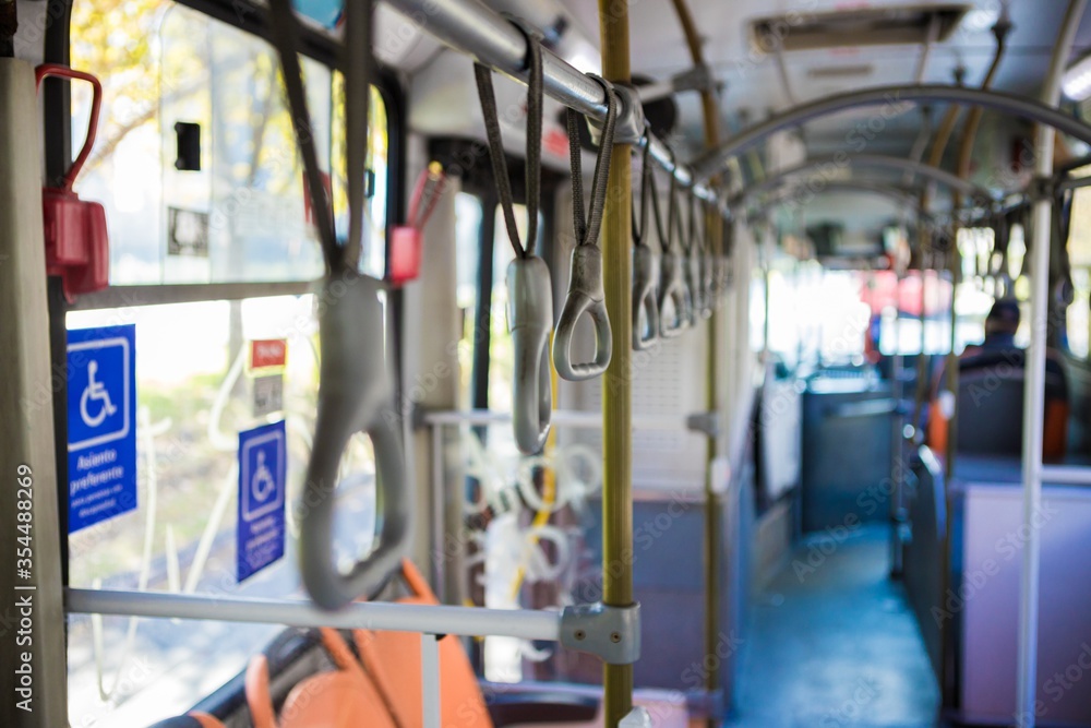 Poster closeup shot of handrails in an empty bus- transport while quarantine concept