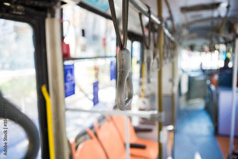 Poster closeup shot of handrails in an empty bus- transport while quarantine concept