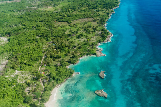 Beach aerial drone view from above on Punta Cana landscape, Bavaro, Saona, Cap Cana tropical ocean sea and palm trees on caribbean coastline with tourists and boats in Dominican republic Cortecito  