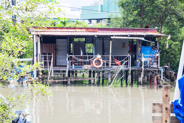 Wooden house by the river side view indicating poverty