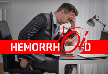Young man suffering from hemorrhoids in office