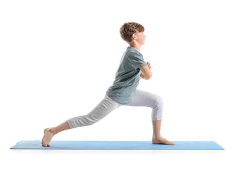 Cute little boy practicing yoga on white background