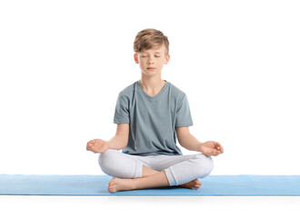 Cute little boy practicing yoga on white background