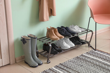 Stylish interior of modern hall with shoes on stand