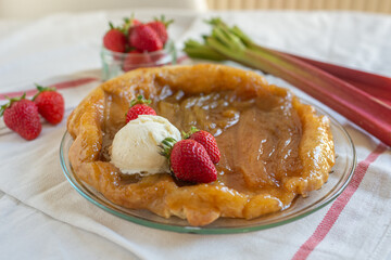 Rhubarb upside down cake with strawberries and ice cream