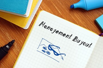 Management Buyout (MBO) inscription on the piece of paper.