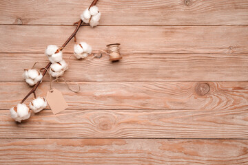 Beautiful cotton branch on wooden background