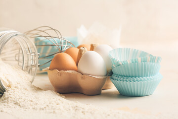 Muffin baking cups with products on white background