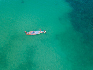 Local fishing boat moored in a bay with clear water.