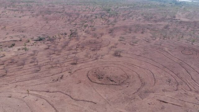 Aerial drone flyby view of rock arrangement for rain water harvesting in the grassland of Pune, Maharashtra, India.